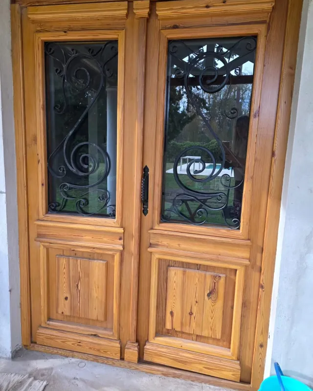 Double colonial door with wrought iron glass panels