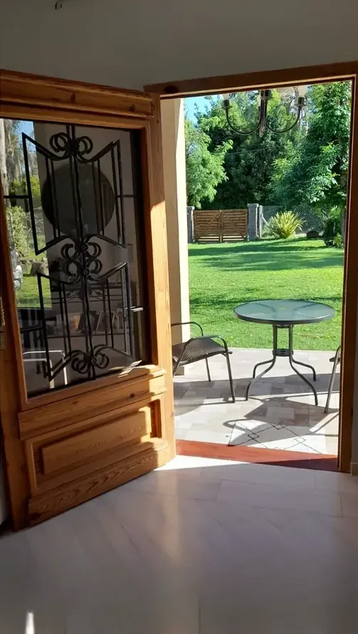Colonial door open onto a garden