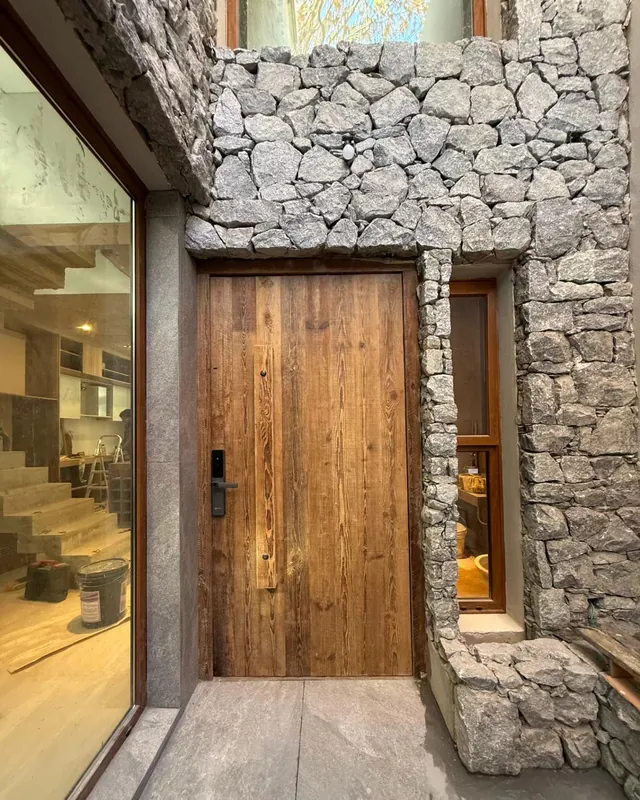 Full-plank heart pine door set in a dry-stone wall